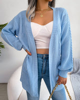 Back view of oversized cable knit cardigan showing dropped shoulder and length