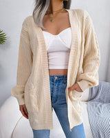 Front view of oversized chunky cable knit open-front cardigan with patch pockets