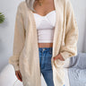 Front view of oversized chunky cable knit open-front cardigan with patch pockets