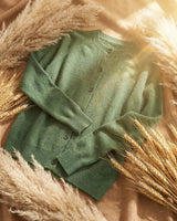 Styled view of the cardigan layered over a collared shirt