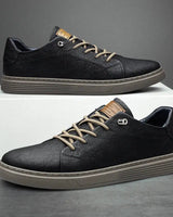 Front view of low-profile faux leather sneaker with ridged sole