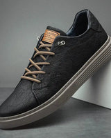 Detail shot showing contrast lacing and stitching on faux leather upper
