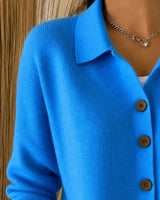 Collared knit cardigan buttoned up, showing ribbed texture and cuff detail