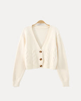 Back view of cropped cable knit cardigan with ribbed hem and cuffs