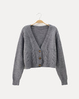 Cropped cable knit cardigan with V-neckline and horn buttons, front view