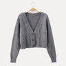 Cropped cable knit cardigan with V-neckline and horn buttons, front view
