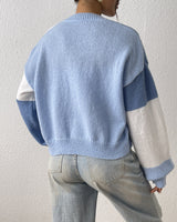 Colour block cardigan showing contrasting panels across body and sleeves