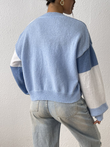 Colour block cardigan showing contrasting panels across body and sleeves