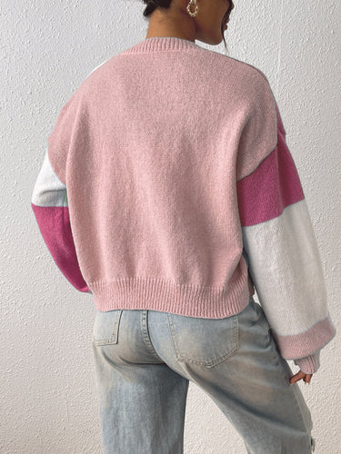 Close-up of ribbed cuffs on colour block cropped cardigan