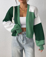 Model wearing cropped colour block cardigan over high-waist jeans