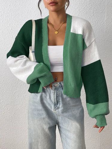 Model wearing cropped colour block cardigan over high-waist jeans