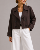 Front view of a cropped double-breasted trench coat with oversized lapels and structured collar