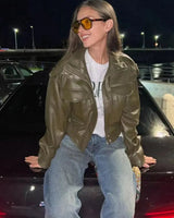 Side view showing the cropped length and ribbed hem of the jacket