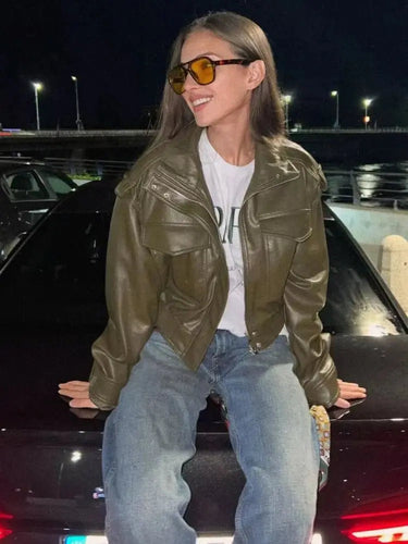 Side view showing the cropped length and ribbed hem of the jacket