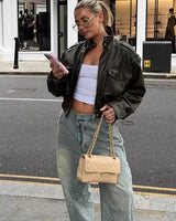 Rear view of the cropped faux leather jacket showing the structured back