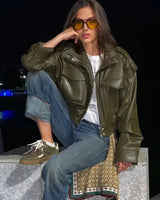 Front view of a cropped faux leather jacket with zip closure and stand collar