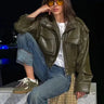 Front view of a cropped faux leather jacket with zip closure and stand collar
