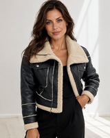 Front view of a cropped leather jacket with oversized fold-over collar and asymmetric zip