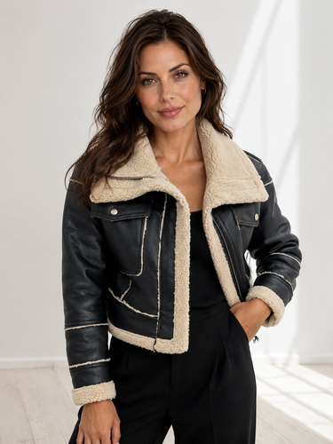 Front view of a cropped leather jacket with oversized fold-over collar and asymmetric zip