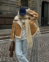 Back view of cropped leather jacket with contrast trim along edges