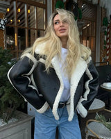 Front view of cropped leather jacket with wide lapel collar and contrast trim