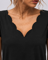Side view showing the flared skirt and midi length of the dress