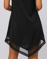 Three-quarter view of the draped midi dress showing skirt flare