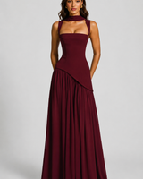 Model walking in the maxi dress showing the movement of the draped skirt
