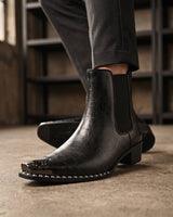 Detail shot of elasticated side panel on faux leather ankle boot