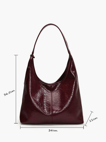 Side view of faux leather hobo bag showing crinkled texture and silhouette