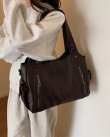 Side profile of the bag highlighting the depth and layered zip compartments