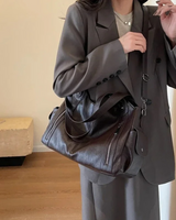 Close-up of the zip fastenings and faux leather texture on the exterior