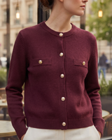 Close-up of embossed coin-style gold buttons on cardigan placket