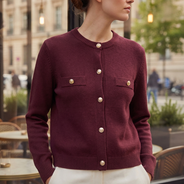 Close-up of embossed coin-style gold buttons on cardigan placket
