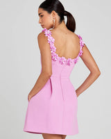 Close-up of floral embellishment detail on the bodice of the mini dress