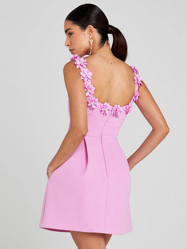 Close-up of floral embellishment detail on the bodice of the mini dress