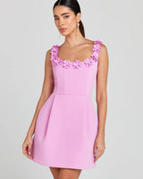 Front view of a floral embellished mini dress with structured silhouette