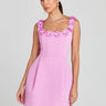 Front view of a floral embellished mini dress with structured silhouette