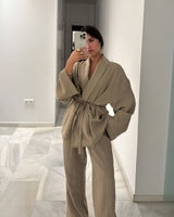 Side view showing the flowing silhouette of the khaki two-piece set