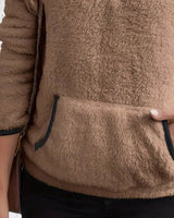 Side view showing long sleeves and relaxed silhouette of the fleece pullover