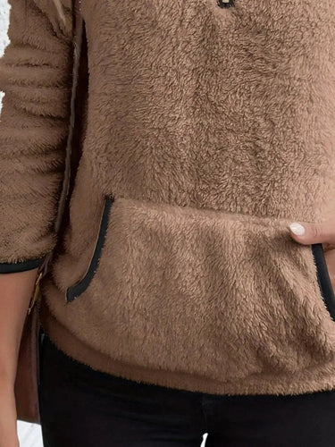 Side view showing long sleeves and relaxed silhouette of the fleece pullover