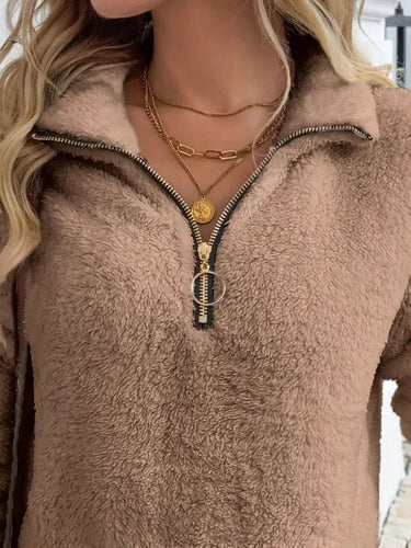 Close-up of the half-zip neckline detail on the teddy fleece cardigan