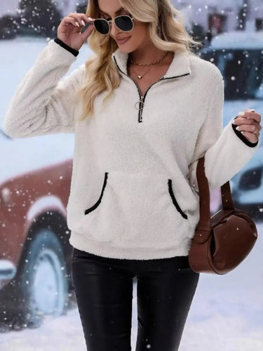 Detail shot of the kangaroo front pocket on the fluffy pullover