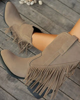 Lifestyle shot of the boots worn with straight-leg jeans