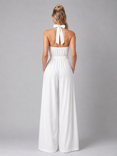 Side view showing the flowing wide-leg silhouette and clean drape of the jumpsuit