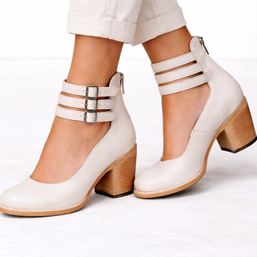 Women's heeled ankle boots styled with tailored trousers, full-length shot