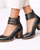 Close-up of block heel and side zip on women's ankle boots