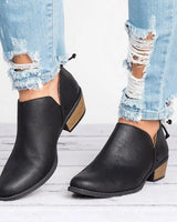 Front view of distressed faux leather ankle boot with V-cut opening