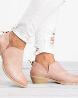 Ankle boots styled with tailored trousers, showing full boot profile