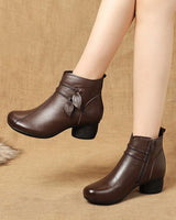 Front-facing view of heeled ankle boot with leaf detail at the ankle